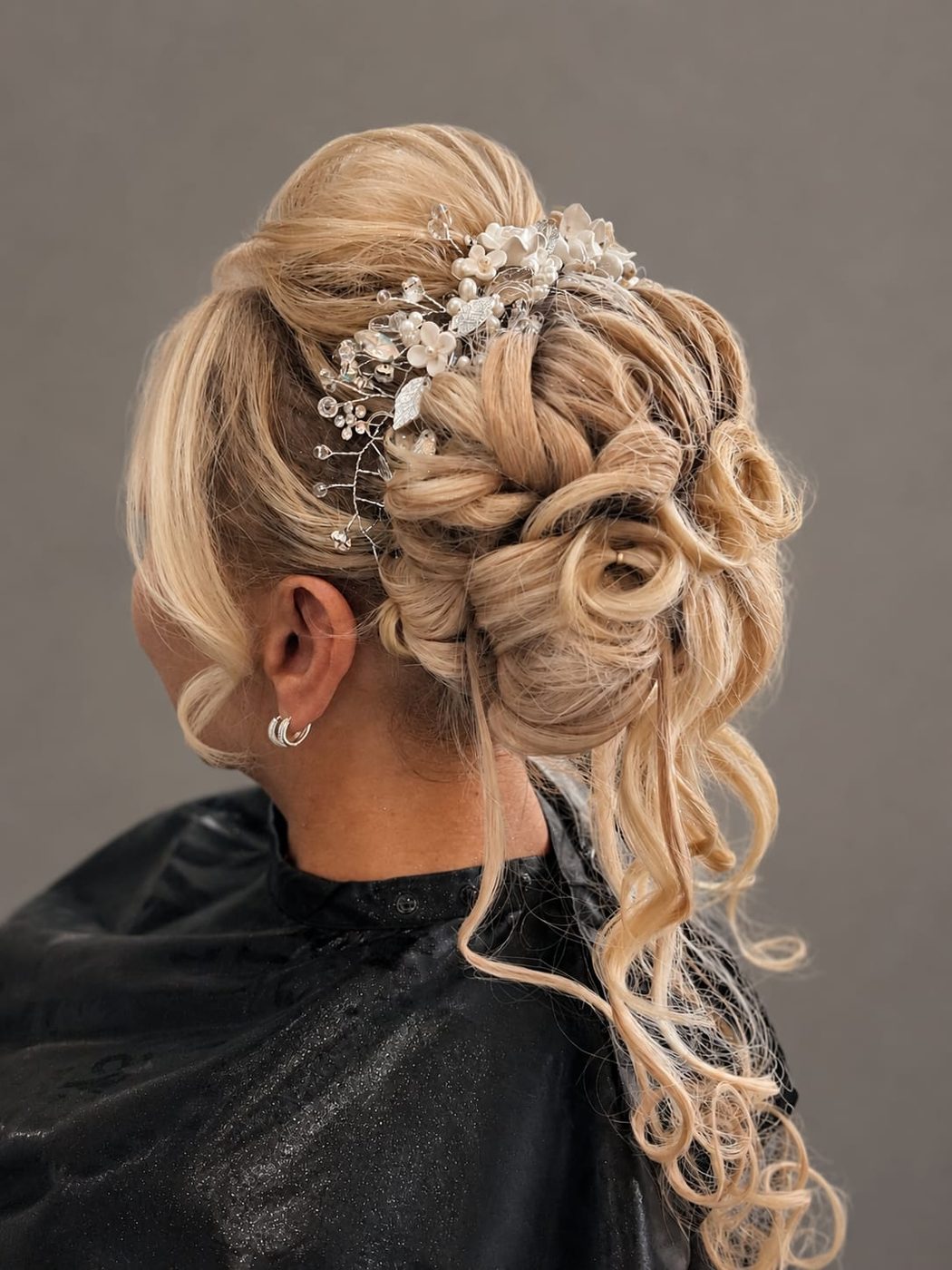 Bridal blonde updo with pearl and crystal headpiece